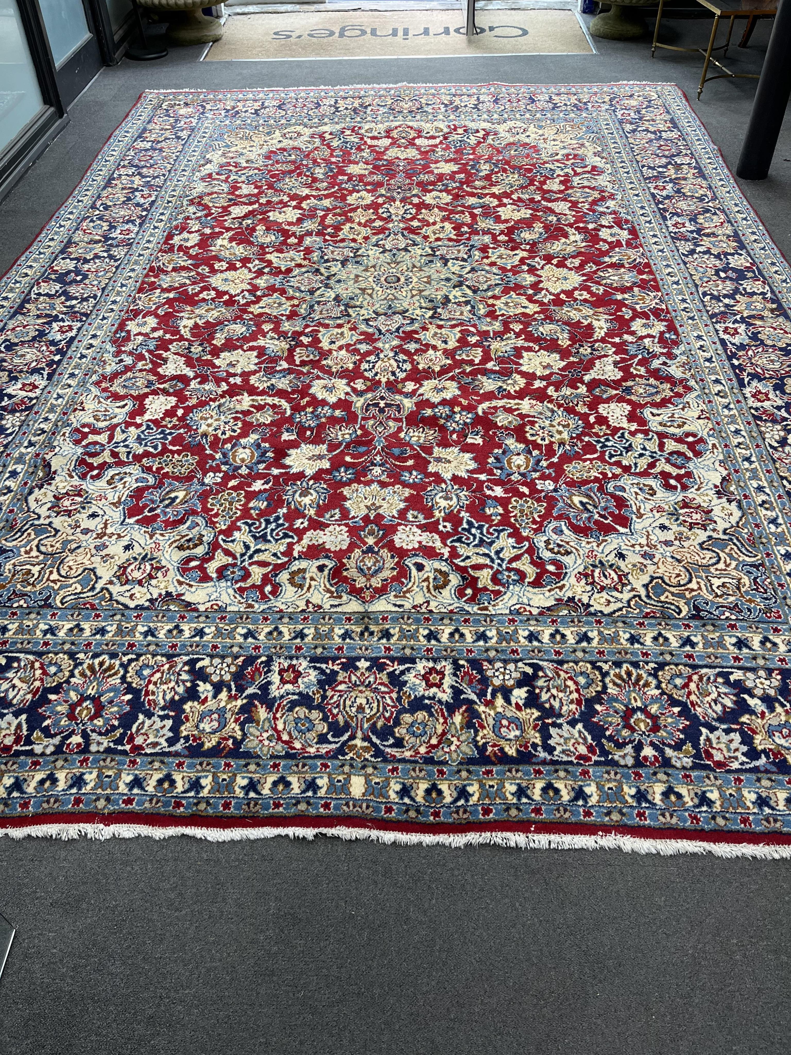 A Persian burgundy ground carpet, 410 x 282cm. Condition - good